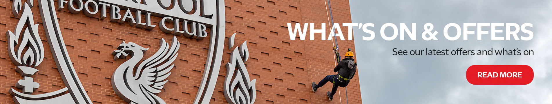Person abseiling by the Liverpool logo, click to see latest offers and what's on