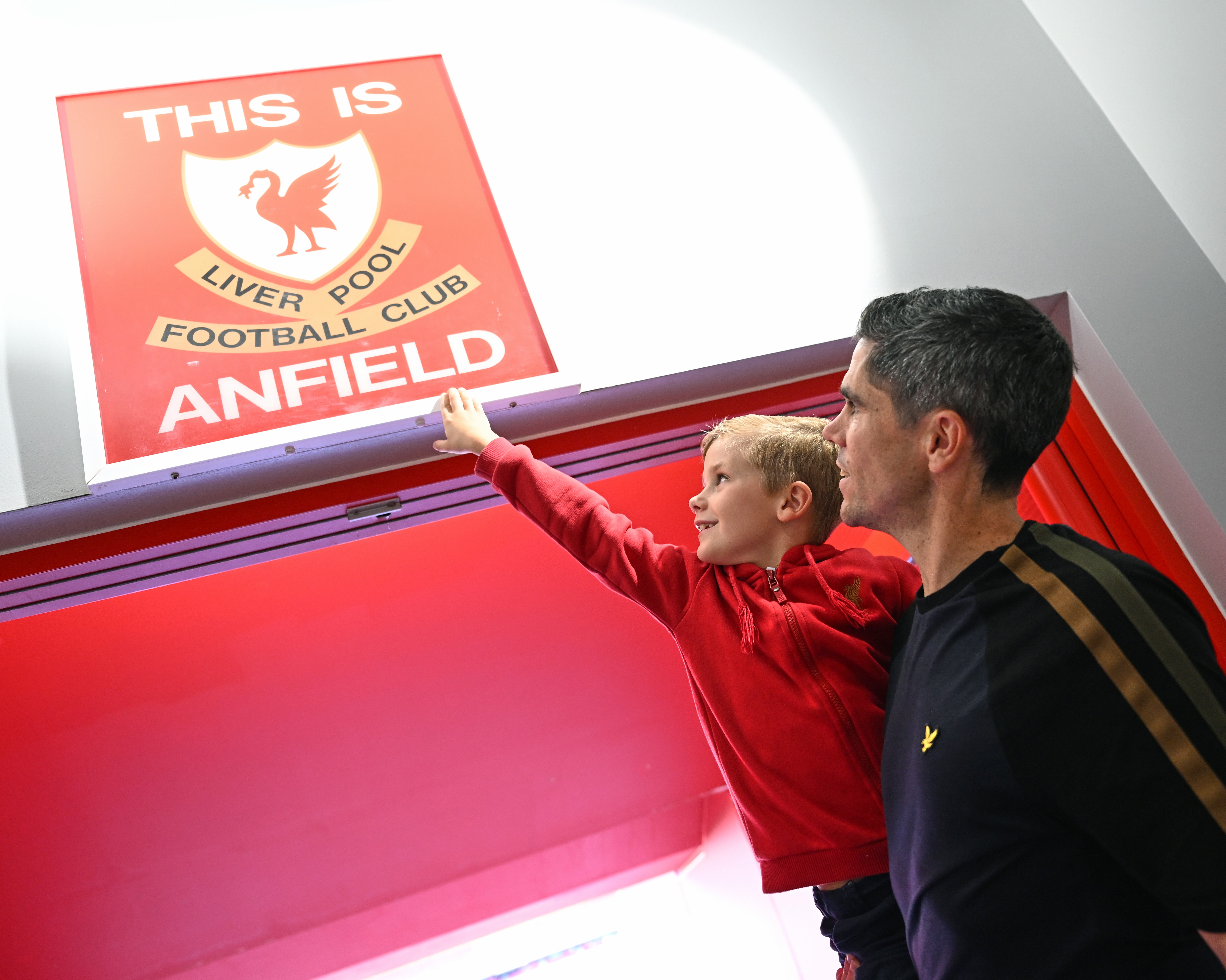 Promotional image for a Liverpool FC 'Best Value Package' with books, a keyring,
                            and magnet set. Includes an 'Epic' book with Anfield Stadium and trophy photos, and an
                            'Essential Guide' book covering the club's history from the Kop to Klopp, and Shankly to
                            Slot, featuring players, managers, and fans.