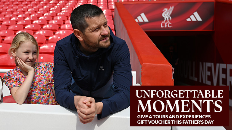 A father and daughter standing by the tunnel looking over the pitch