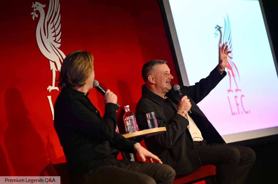 Four men seated on stage talking to the audience