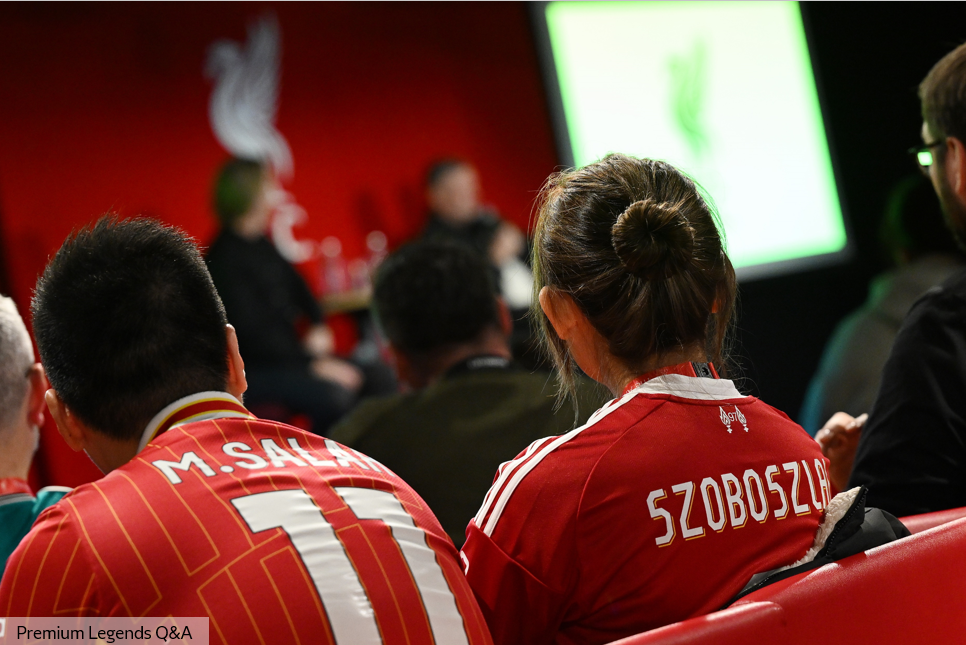 Four men seated on stage talking to the audience