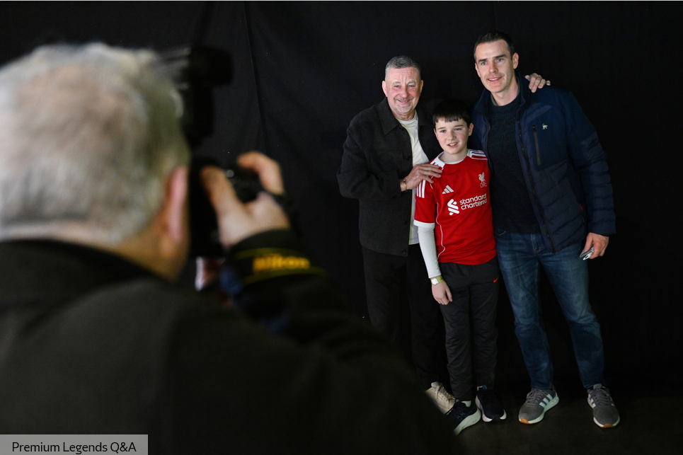 Four men seated on stage talking to the audience