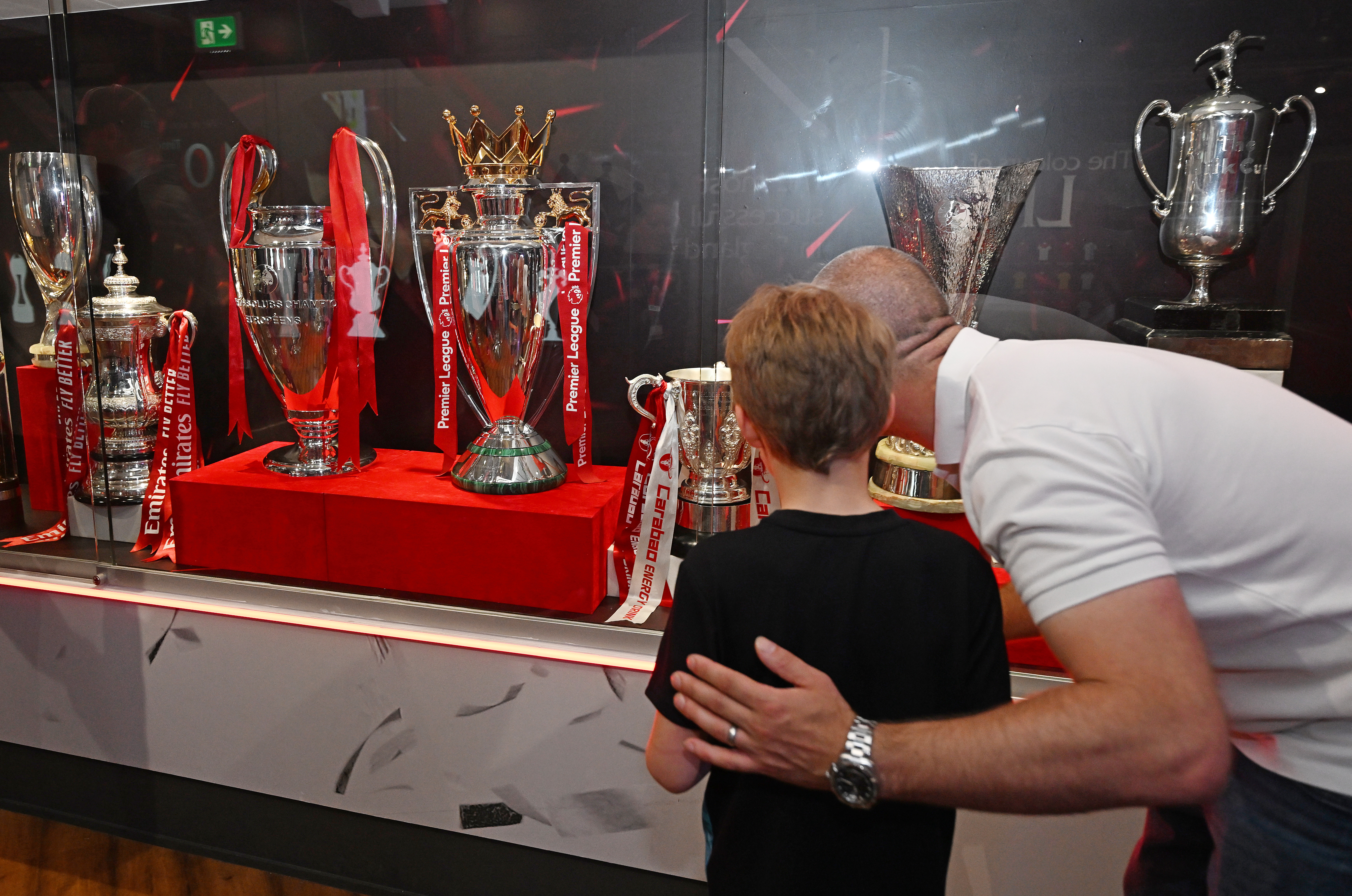 Two display cases housing memorabilia within the LFC Museum â Danke Jurgen room, with âJurgen Kloppâ lettering, signature and image on the wall behind. Memorabilia housed is section of 6 programmes, 3 football shirts and items belonging to Jurgen