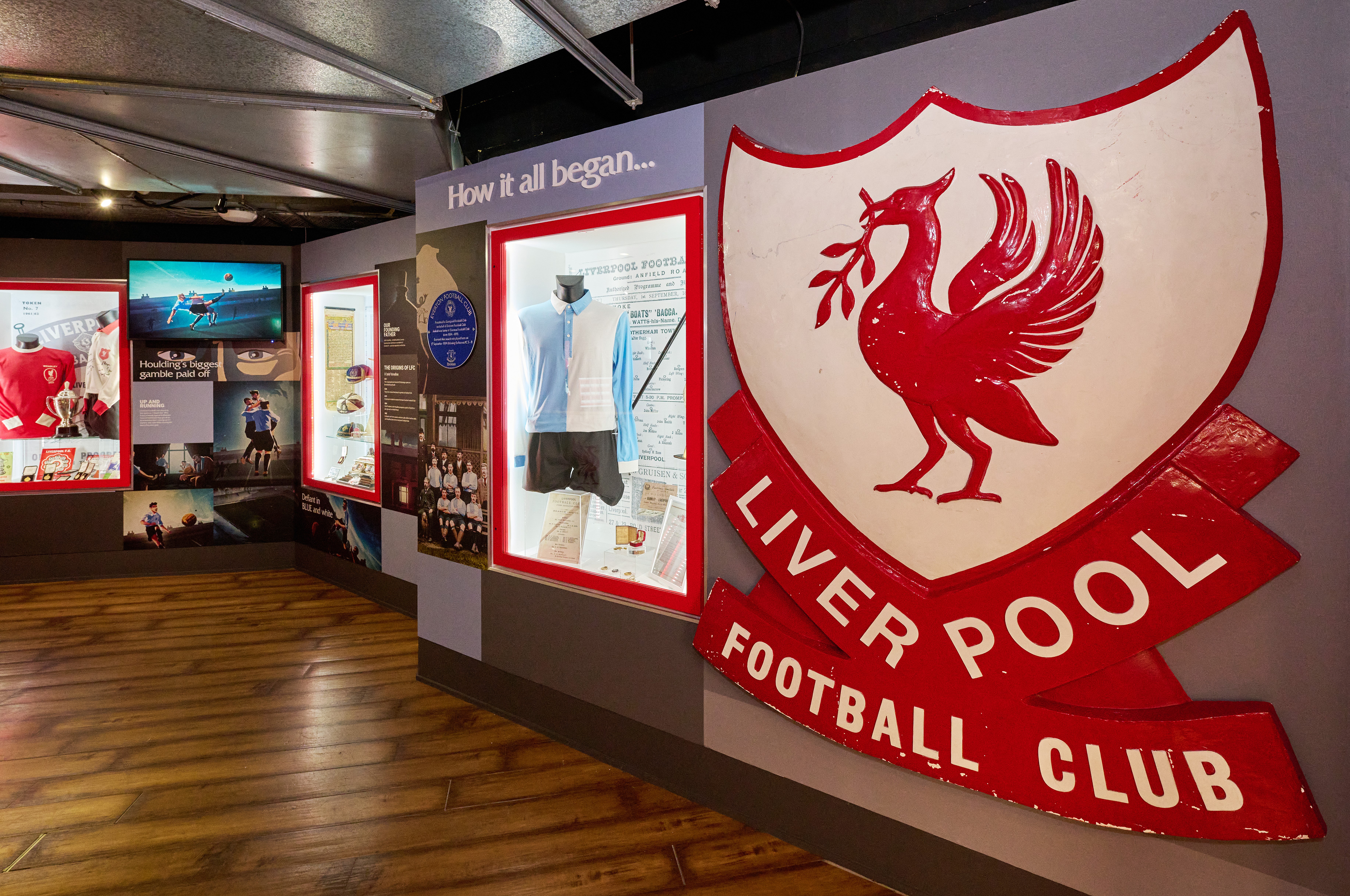 Two display cases housing memorabilia within the LFC Museum â Danke Jurgen room, with âJurgen Kloppâ lettering, signature and image on the wall behind. Memorabilia housed is section of 6 programmes, 3 football shirts and items belonging to Jurgen