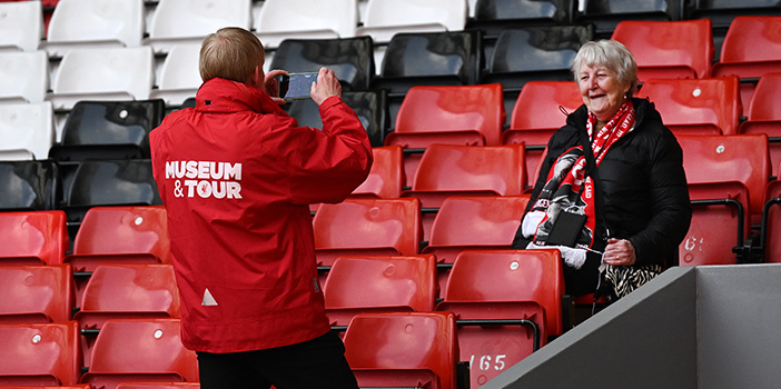 Fan getting a photo taken in the stands