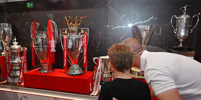 Fans looking at the premier league trophy